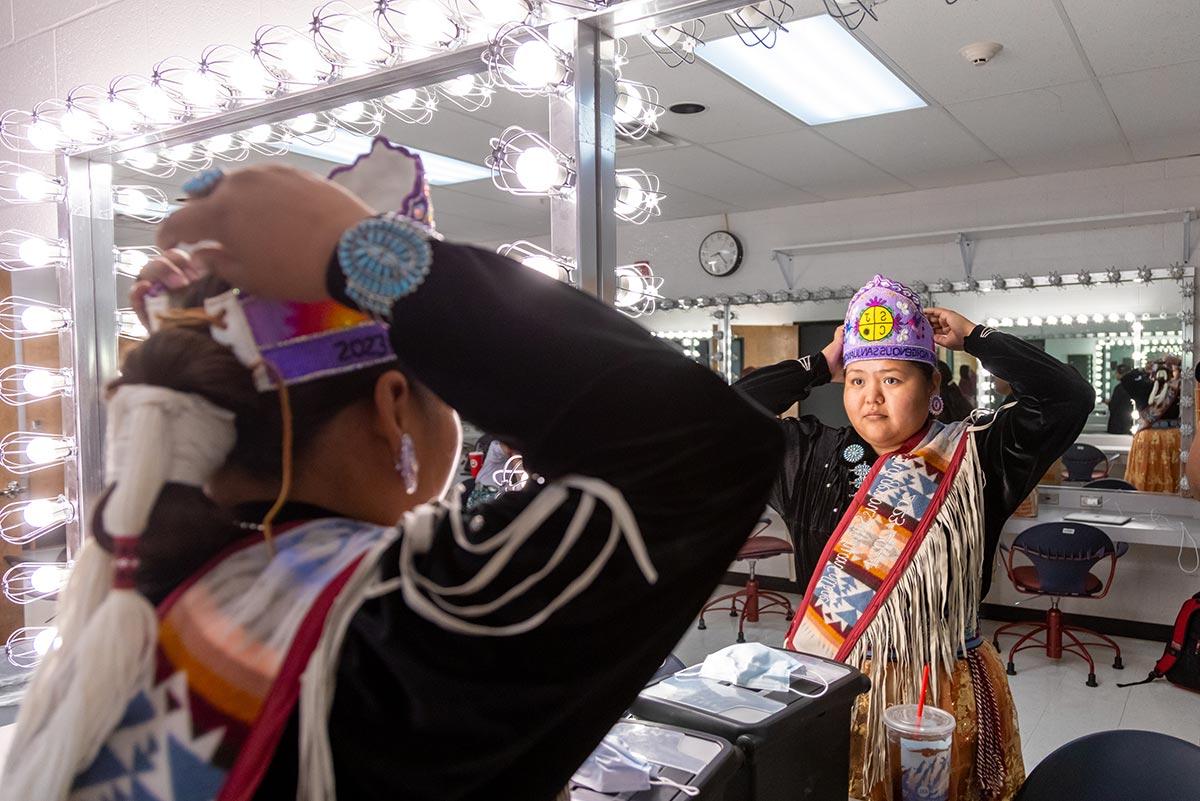 San Juan College Ms. Indigenous looking at herself in the mirror before Ms. Indigenous Pageant.